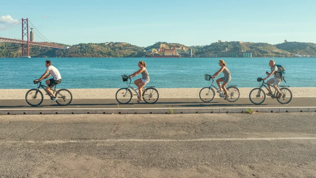 Cyclists On Lisbon Riverside