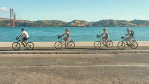 Cyclists On Lisbon Riverside